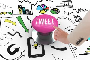 The word tweet and businesswoman pointing against pink push button